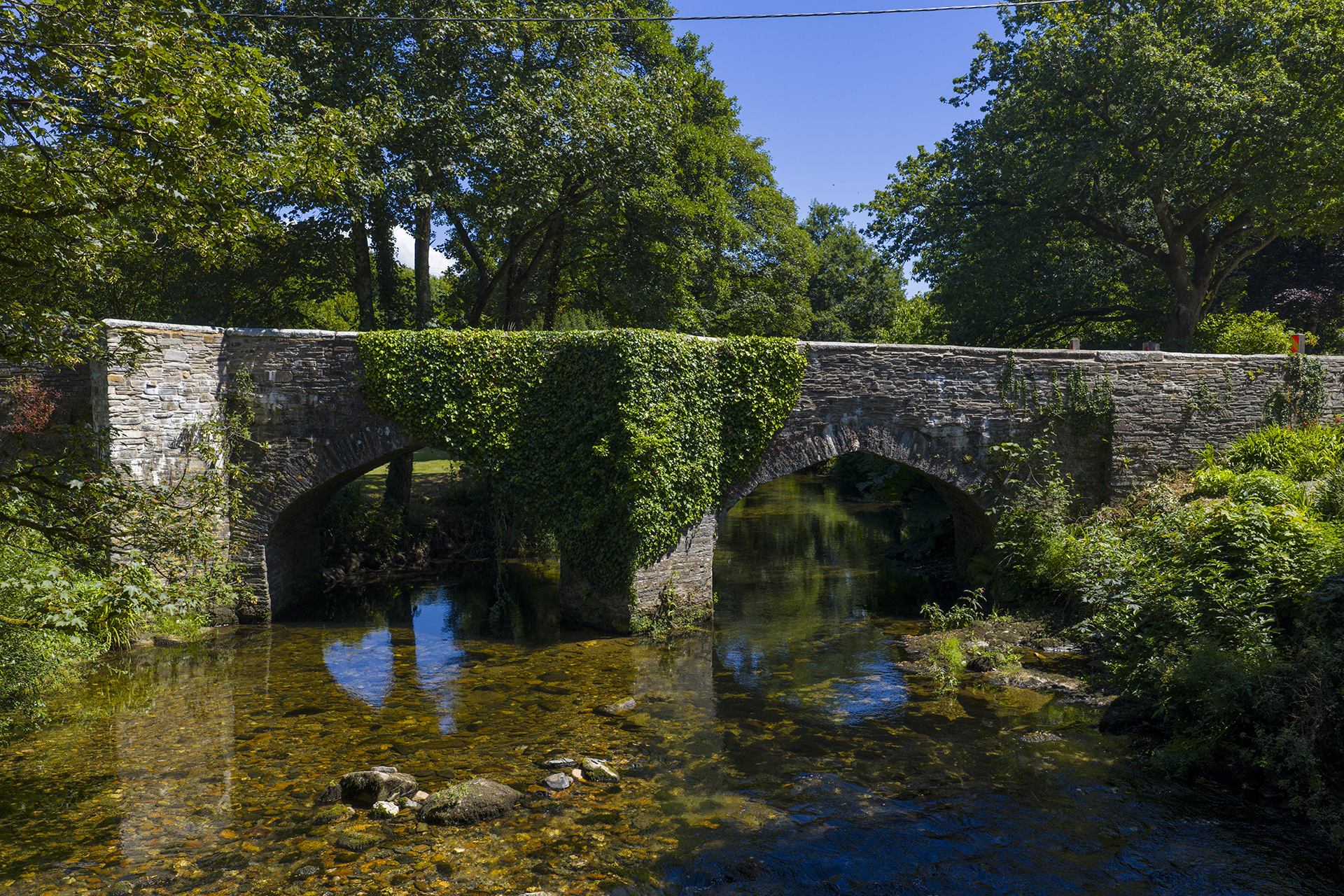 Helland Bridge, a historic stone bridge over a woodland stream Bodmin, North Cornwall