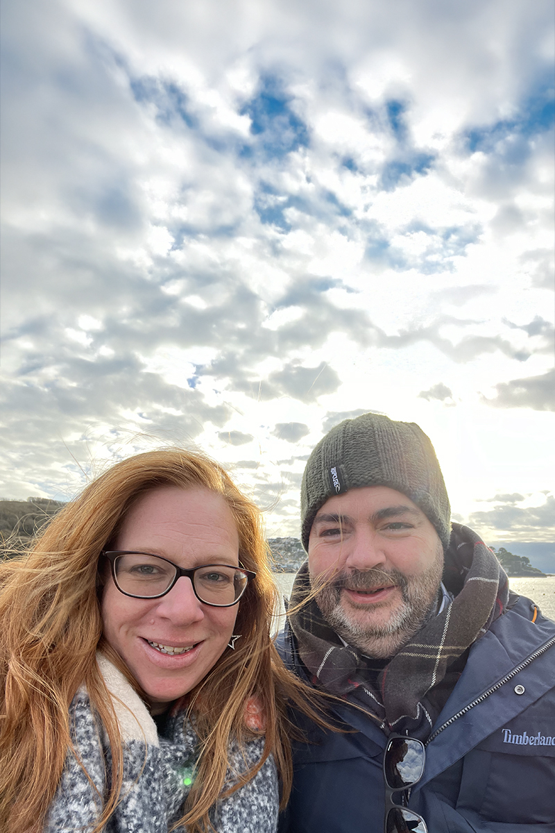 Katy Falconer, co-founder of SeaMoor Stays, enjoying a coastal walk on Polzeath Beach in North Cornwall