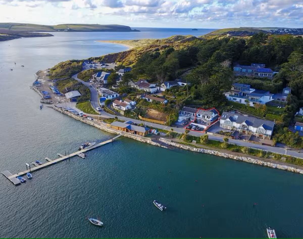 Aerial view of Rock, Cornwall showing The Old Boathouse highlighted in red beside the Camel Estuary