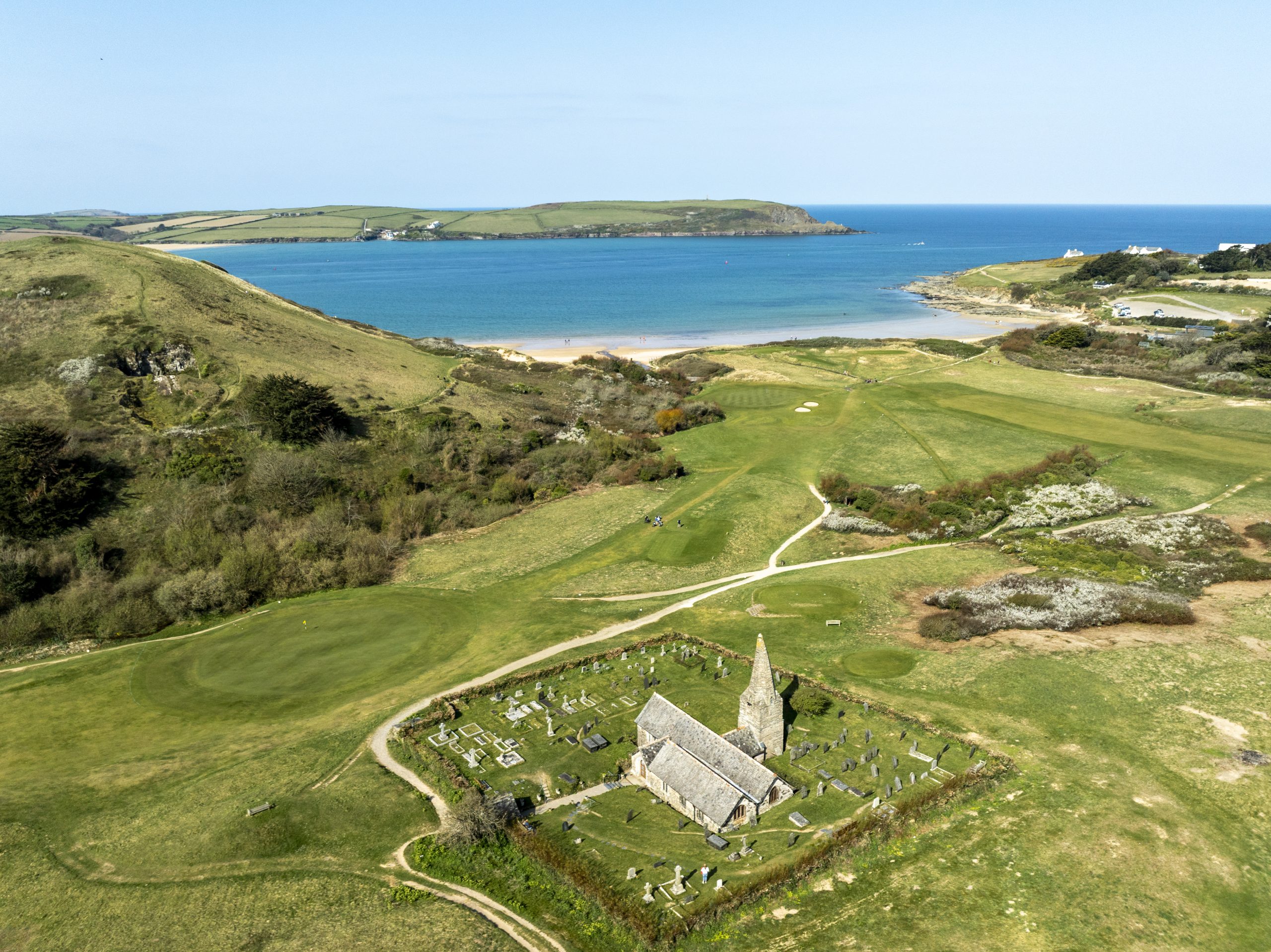 St Enodoc Church and coastline near Rock in Cornwall close to St Minver