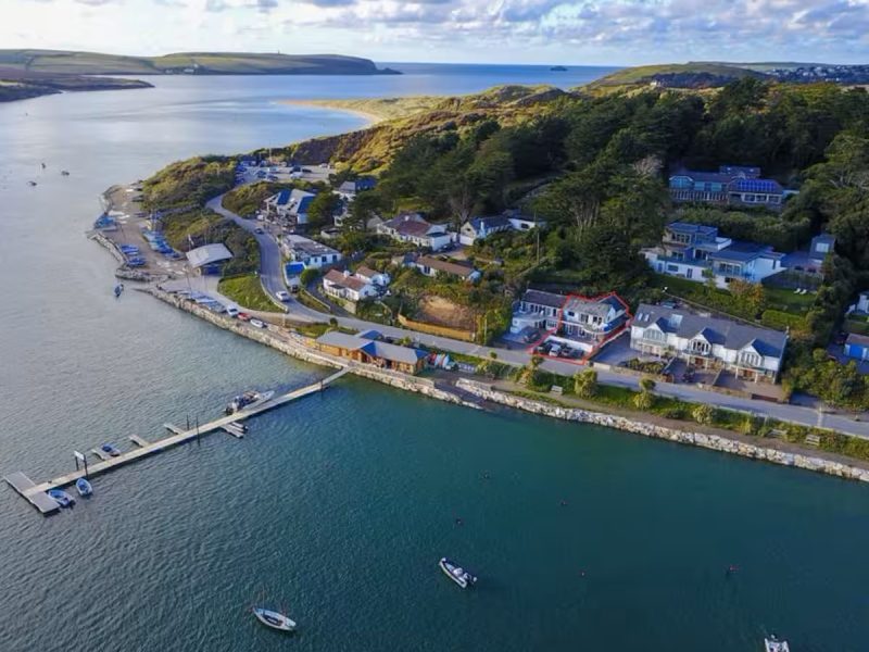 Aerial view of Rock, Cornwall showing The Old Boathouse highlighted in red beside the Camel Estuary