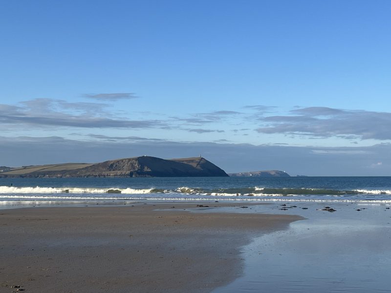 Daymer Bay beach in North Cornwall with waves and coastal headland